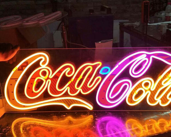neon sign with the wording "coca cola"