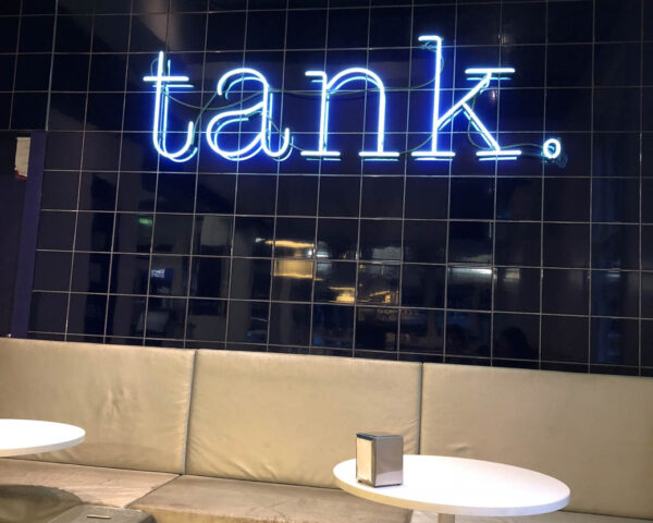 blue neon signage with wordings "tank"