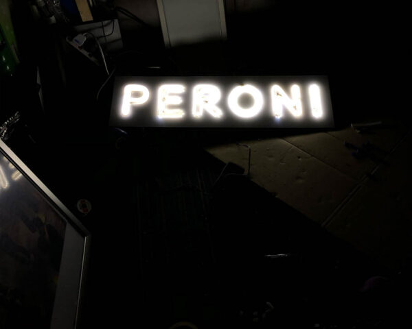 neon sign with the wording "peroni"